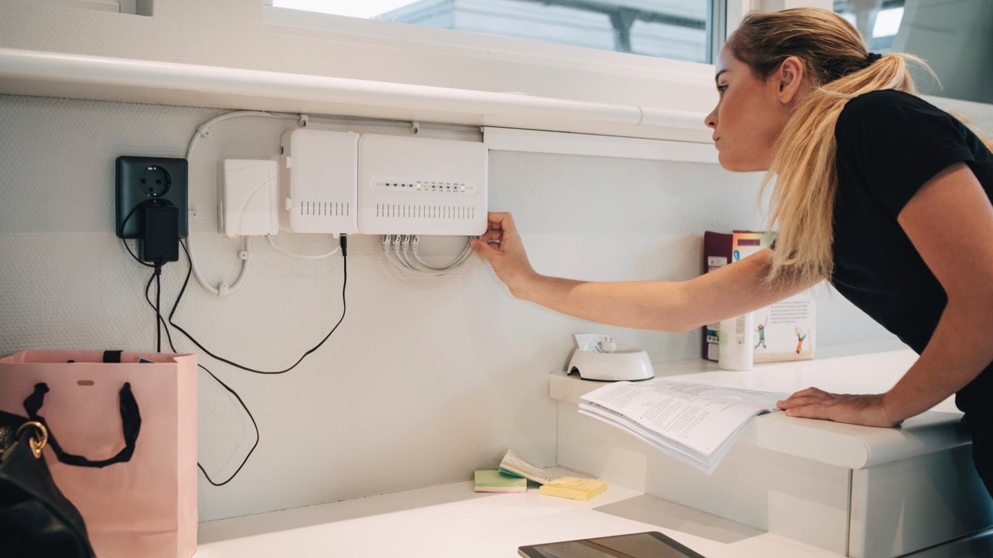 woman attempting to boost Wi-fi signal