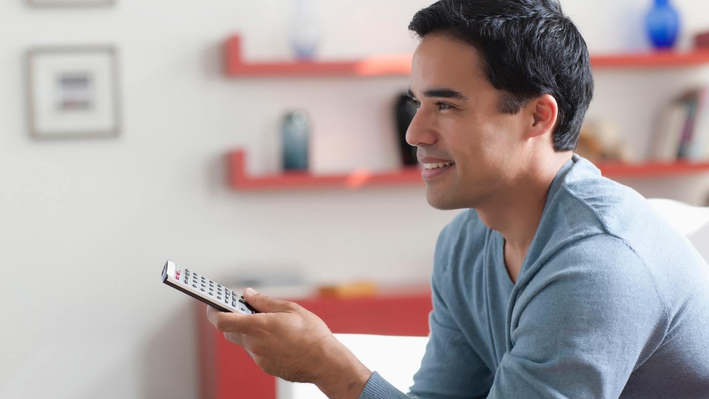 man watching DIRECTV learning how to reset DIRECTV remote