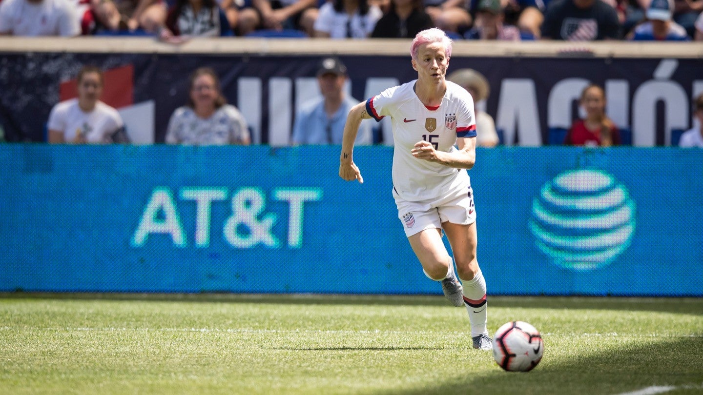 Photograph of Megan Rapinoe dribbling a soccer ball