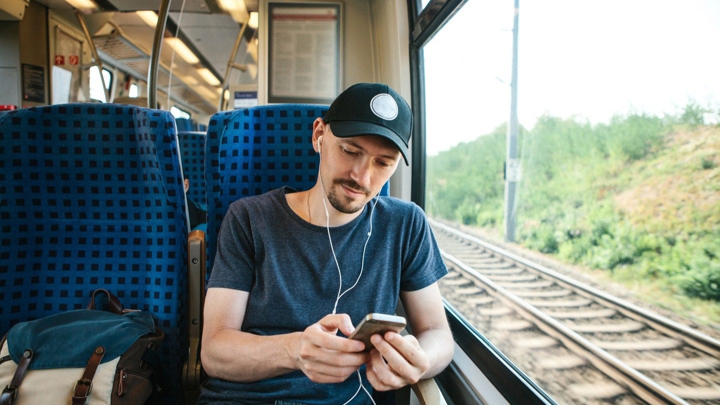 Man using cellphone on a train