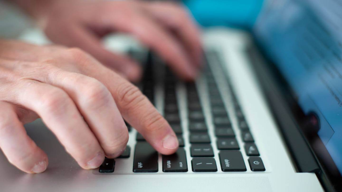 Hands typing on computer