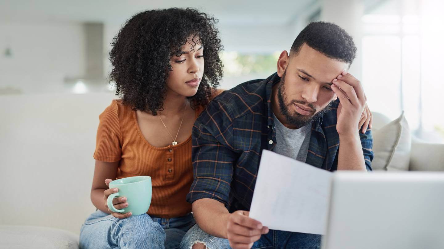 Young couple looking stressed about finances